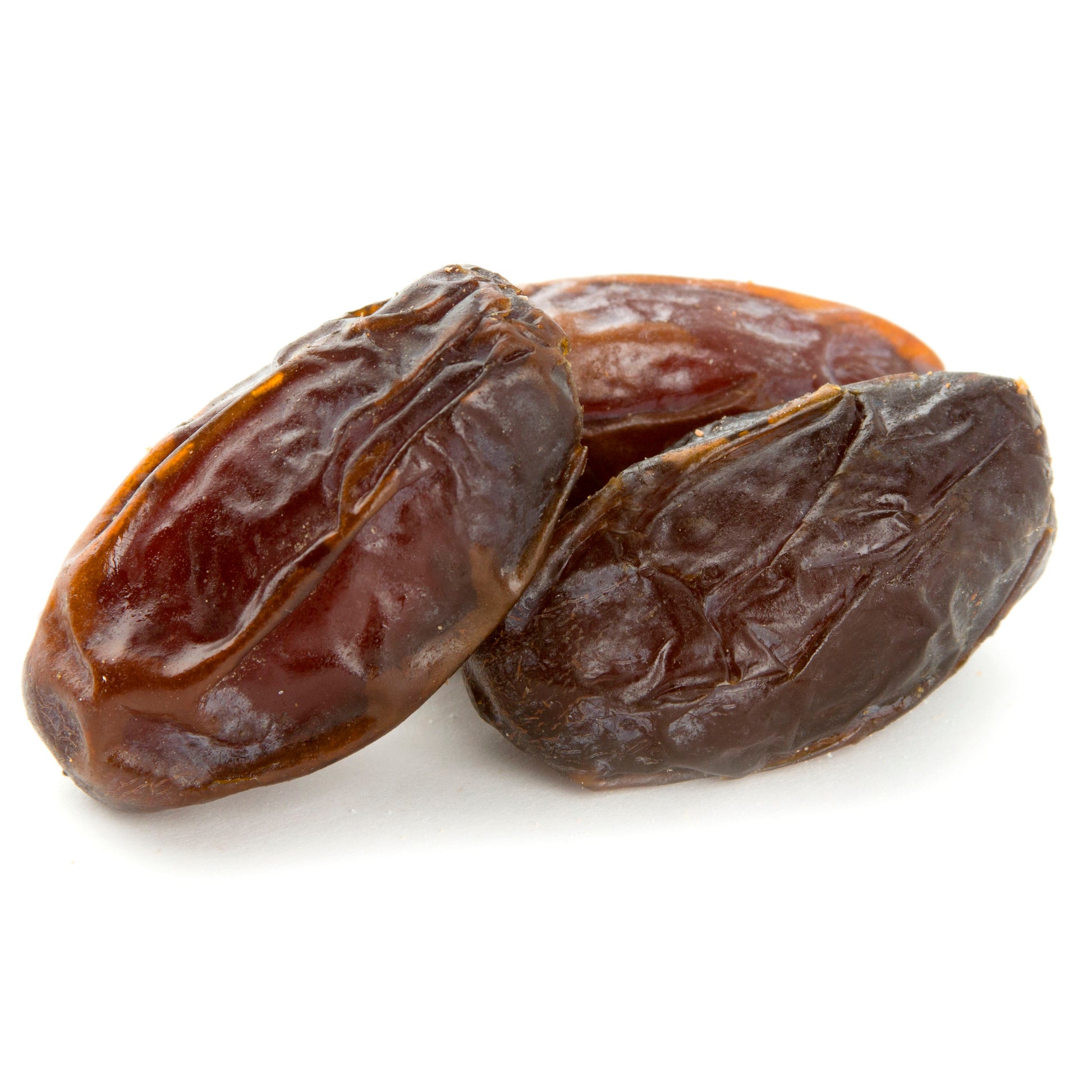 Three Jumbo Medjool dates isolated on a white background.